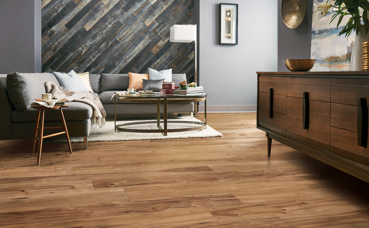 Wide plank oak living room with wood panel wall 