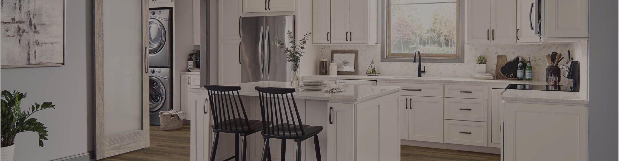 White cabinetry in a kitchen with wood-look floors